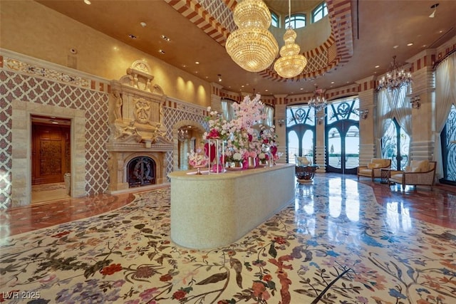 9103 Alta Dr Unit 404, Las Vegas, NV 89145 - reception featuring a chandelier, french doors, and a fireplace with raised hearth