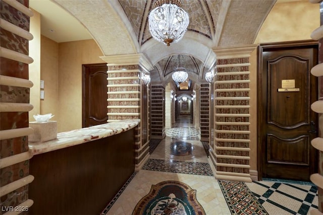 9103 Alta Dr Unit 404, Las Vegas, NV 89145 - interior space featuring arched walkways, an inviting chandelier, decorative columns, and lofted ceiling
