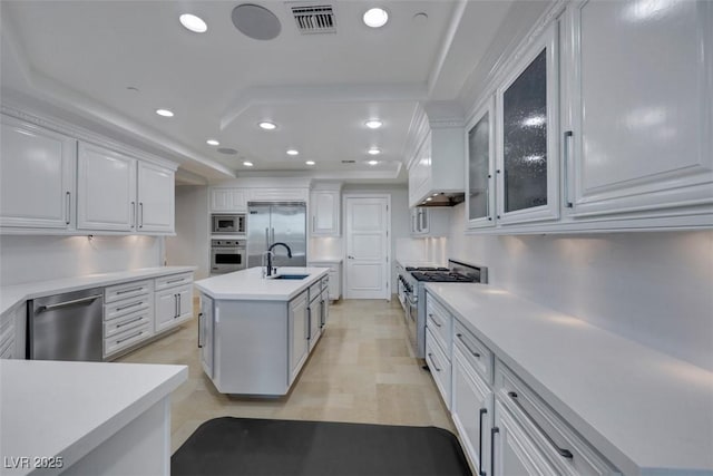 9103 Alta Dr Unit 404, Las Vegas, NV 89145 - kitchen featuring visible vents, white cabinets, built in appliances, a sink, and a tray ceiling