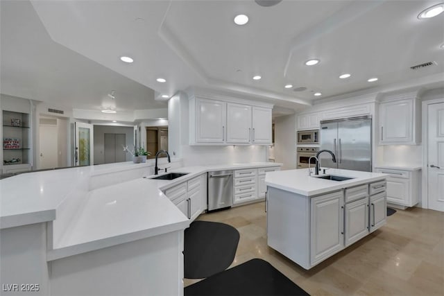 9103 Alta Dr Unit 404, Las Vegas, NV 89145 - kitchen with a sink, visible vents, built in appliances, and a peninsula