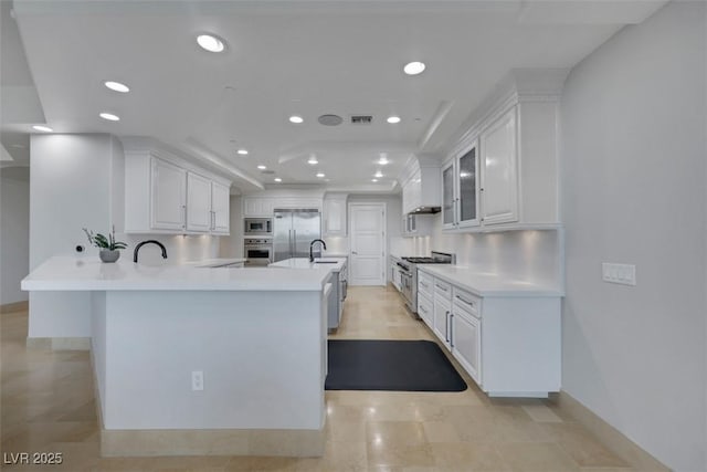 9103 Alta Dr Unit 404, Las Vegas, NV 89145 - kitchen featuring visible vents, white cabinets, built in appliances, a sink, and a peninsula
