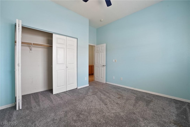 unfurnished bedroom with carpet floors, a closet, baseboards, and a ceiling fan