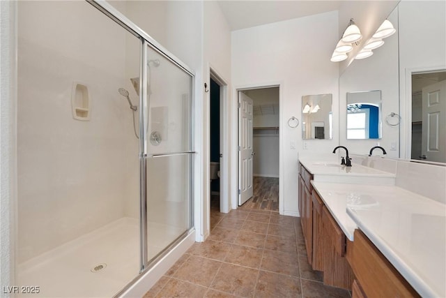 bathroom featuring a shower stall, tile patterned flooring, and vanity