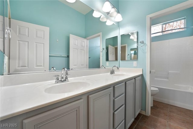 bathroom with tile patterned flooring, a sink, toilet, and double vanity