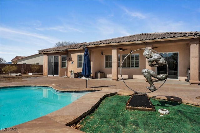 rear view of house featuring ceiling fan, a patio area, and stucco siding