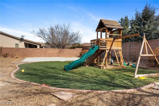 view of playground featuring a fenced backyard and a lawn