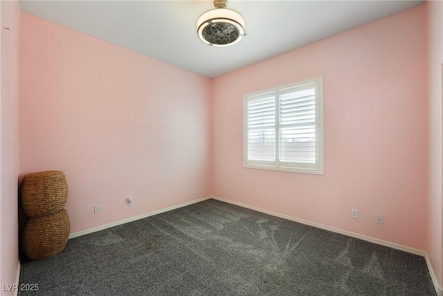 empty room with baseboards and dark colored carpet