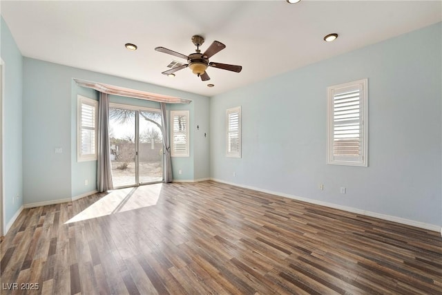 unfurnished room with a ceiling fan, baseboards, and wood finished floors