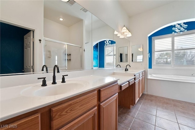 bathroom featuring double vanity, a stall shower, tile patterned floors, a sink, and a bath