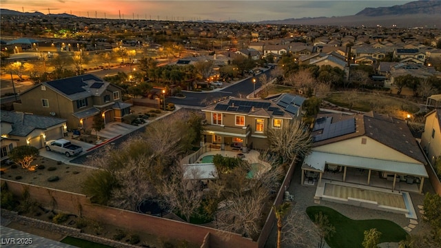 aerial view at dusk featuring a residential view