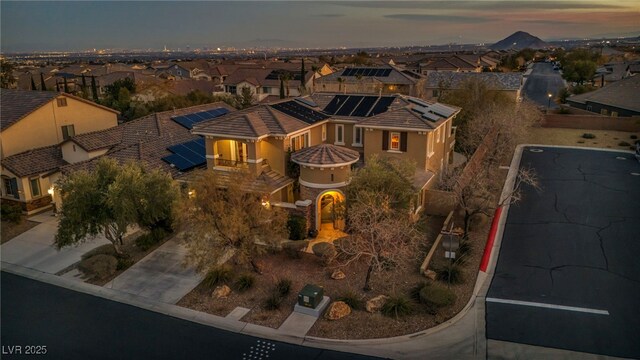 aerial view at dusk featuring a residential view