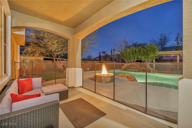 exterior space with an outdoor living space with a fire pit and fence