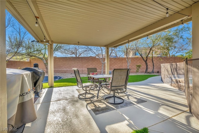 view of patio / terrace featuring outdoor dining area, a fenced backyard, and a grill