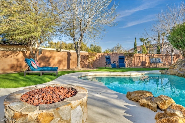 view of pool with an outdoor fire pit and a fenced backyard