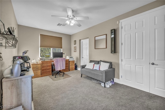 carpeted office with visible vents, ceiling fan, and baseboards