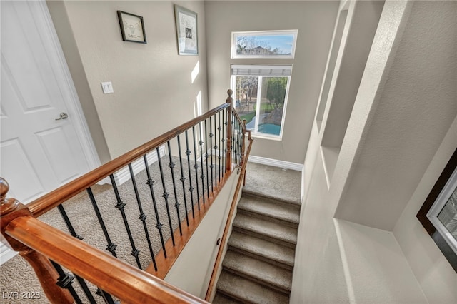 stairway with carpet and baseboards