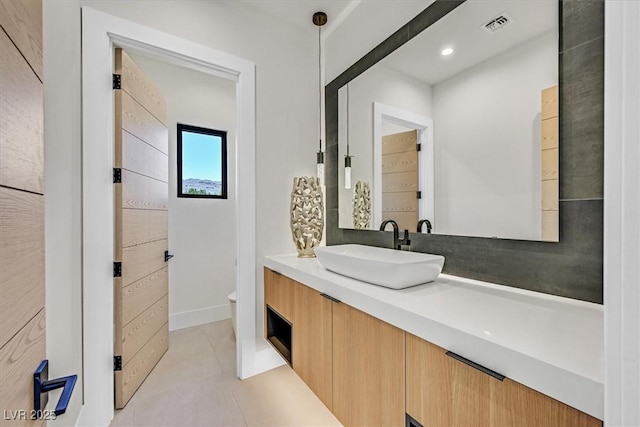 bathroom featuring vanity, toilet, and tile patterned floors