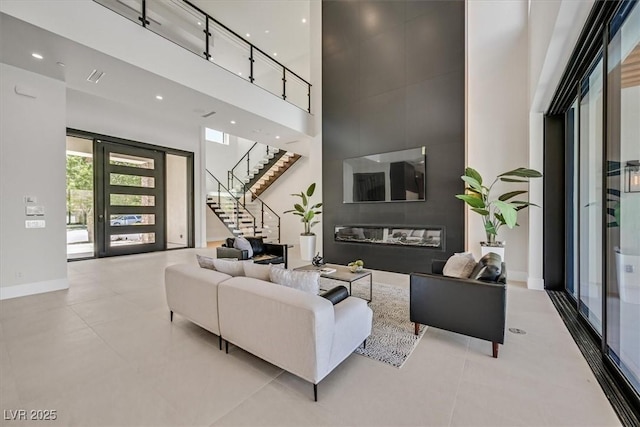 living room featuring a towering ceiling