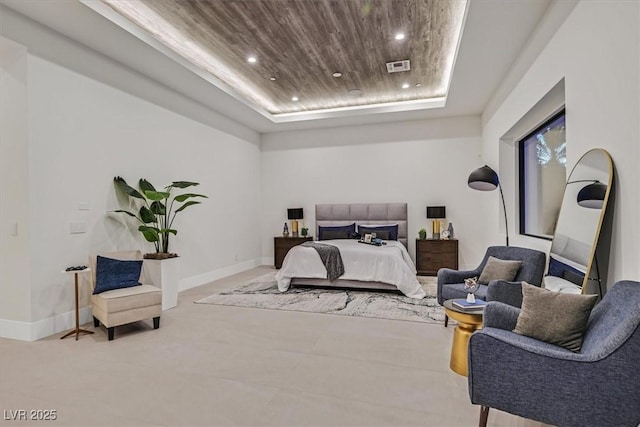 bedroom with wood ceiling and a raised ceiling