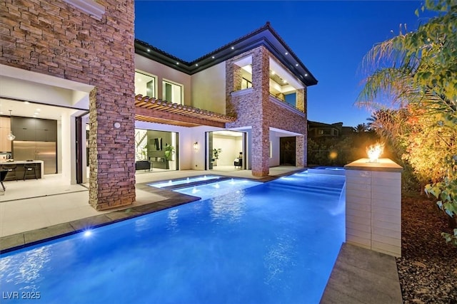 exterior space featuring a patio, a pergola, and pool water feature