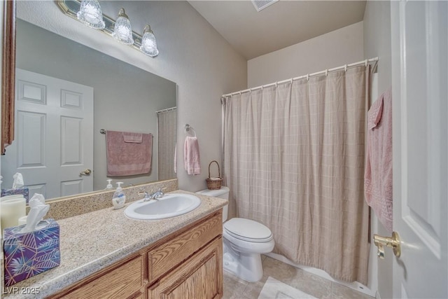 bathroom with vanity, toilet, and tile patterned floors