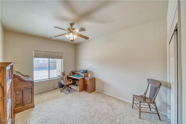 carpeted office with ceiling fan