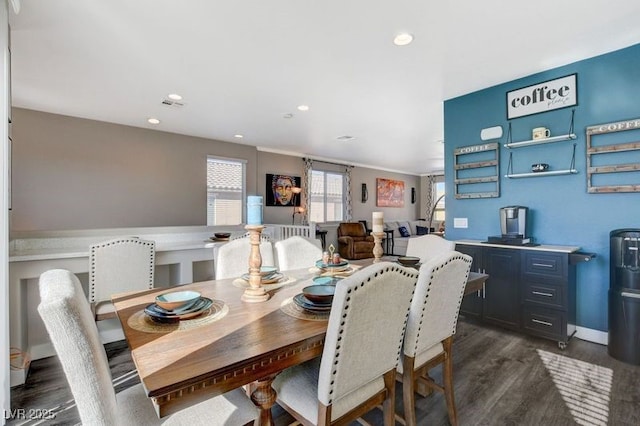 dining space with dark hardwood / wood-style flooring