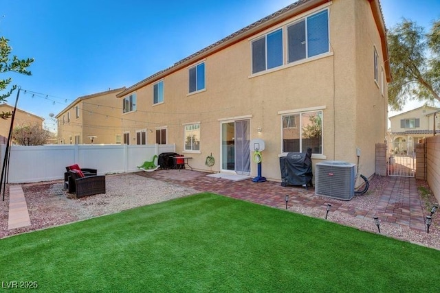 rear view of property with a yard, a patio, and cooling unit