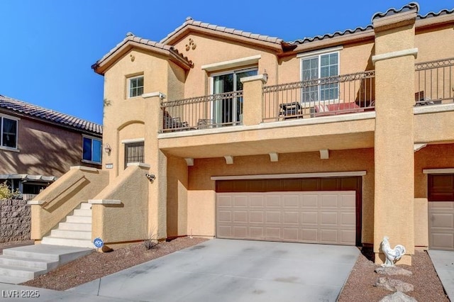 view of property with a garage and a balcony