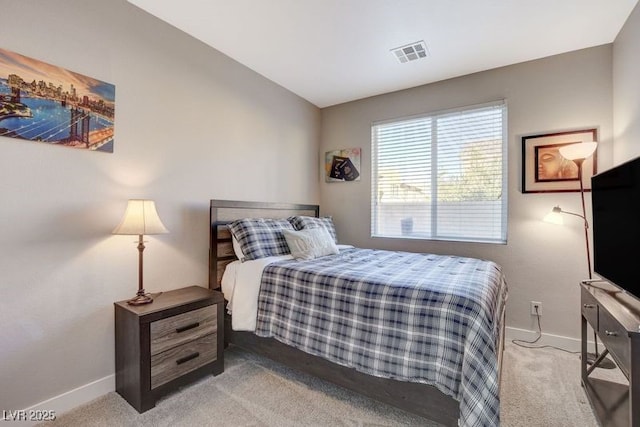 bedroom featuring vaulted ceiling and light colored carpet