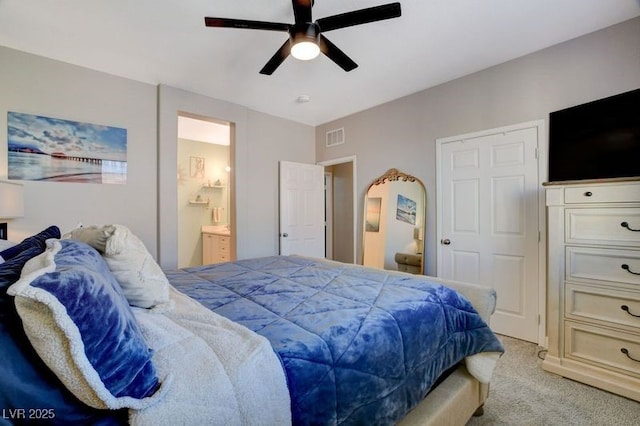 bedroom featuring light carpet, connected bathroom, and ceiling fan