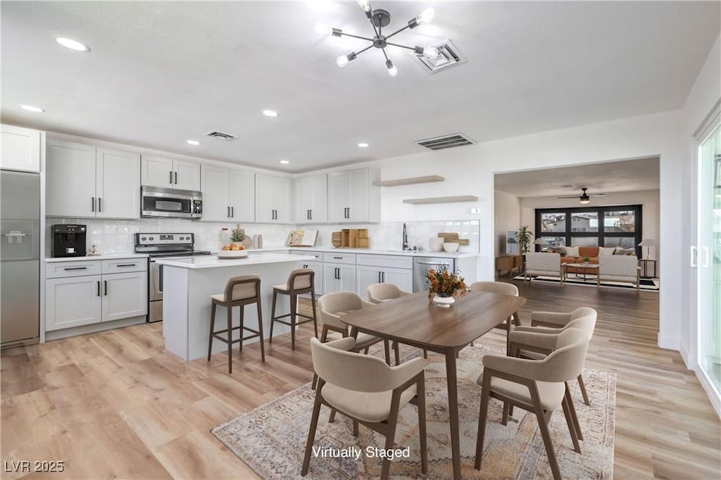 dining room featuring light hardwood / wood-style flooring and sink