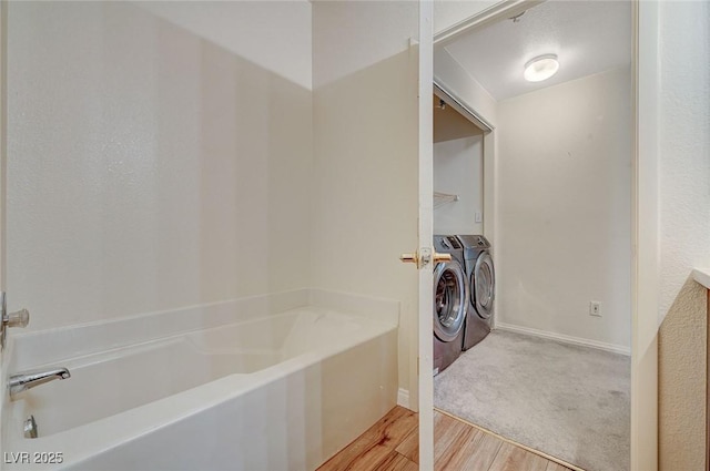 laundry area featuring independent washer and dryer and light wood-type flooring