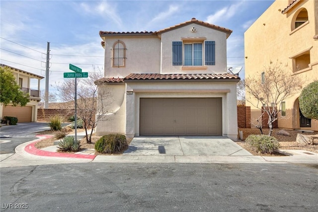 mediterranean / spanish home with a garage