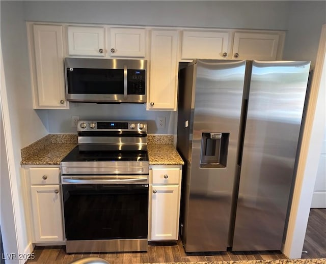 kitchen featuring white cabinetry, light stone countertops, and appliances with stainless steel finishes