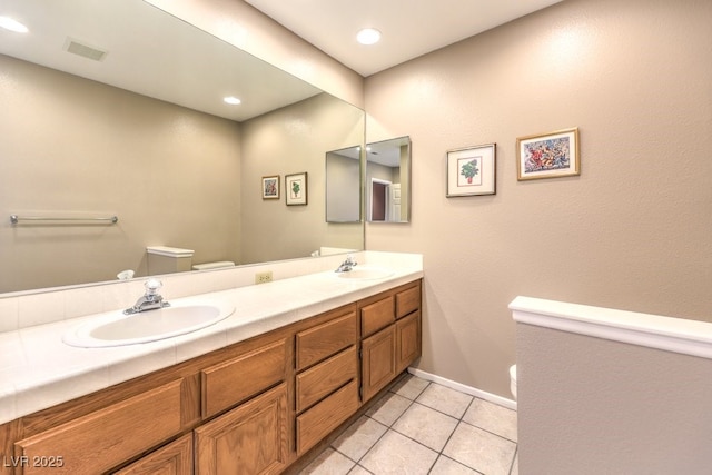 bathroom with vanity, toilet, and tile patterned floors