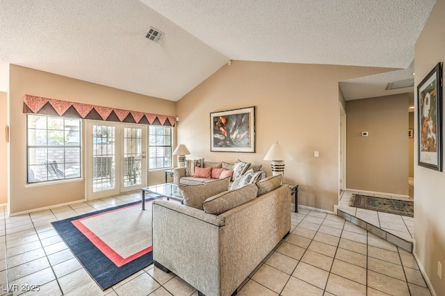 tiled living room with vaulted ceiling and a textured ceiling