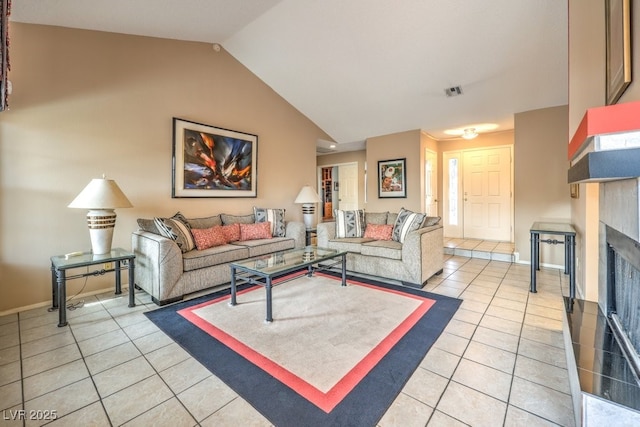 living room with tile patterned flooring and vaulted ceiling