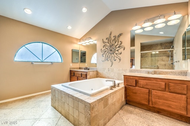 bathroom featuring lofted ceiling, independent shower and bath, plenty of natural light, and vanity