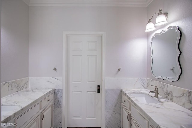 bathroom featuring tile walls, ornamental molding, and vanity