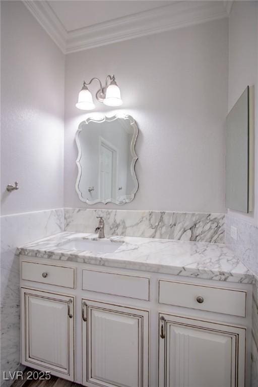 bathroom featuring ornamental molding and vanity