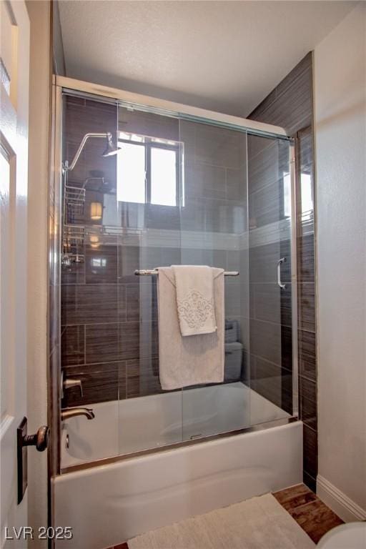 bathroom with shower / bath combination with glass door and hardwood / wood-style flooring