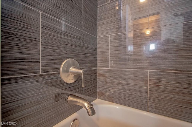 interior details featuring tiled shower / bath