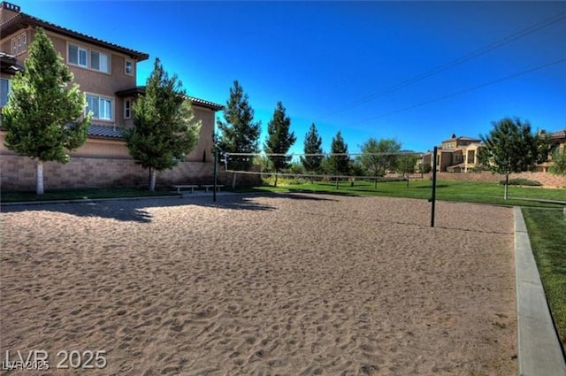 view of community featuring a lawn and volleyball court