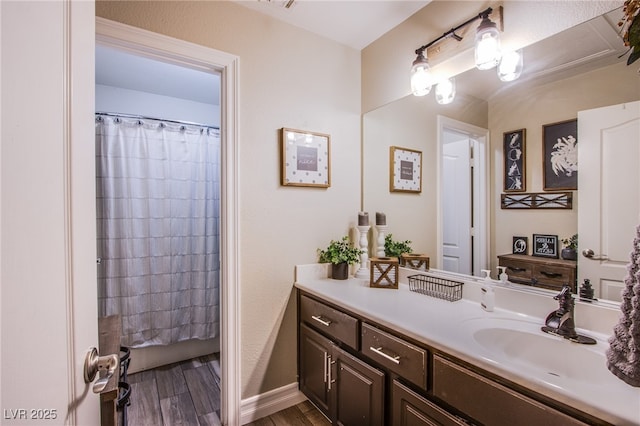 bathroom with a shower with shower curtain, hardwood / wood-style flooring, and vanity