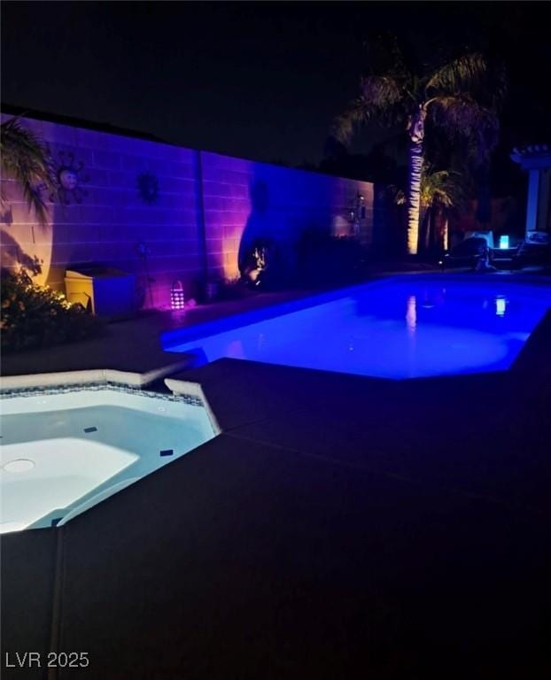 view of pool at night