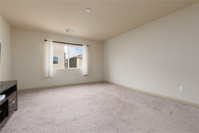 spare room featuring light colored carpet