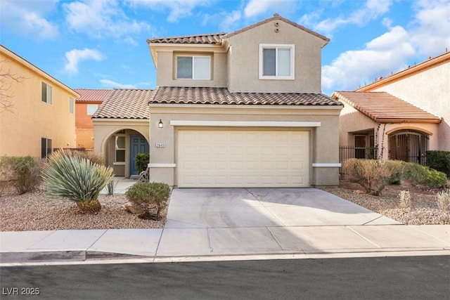 mediterranean / spanish-style house with stucco siding, an attached garage, a tile roof, and concrete driveway