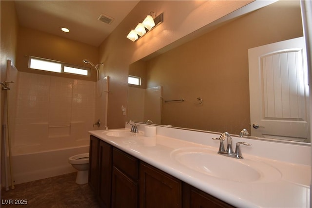 full bath featuring a sink, visible vents, shower / washtub combination, and toilet