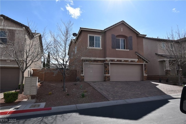 view of front of property featuring stucco siding, decorative driveway, and a garage